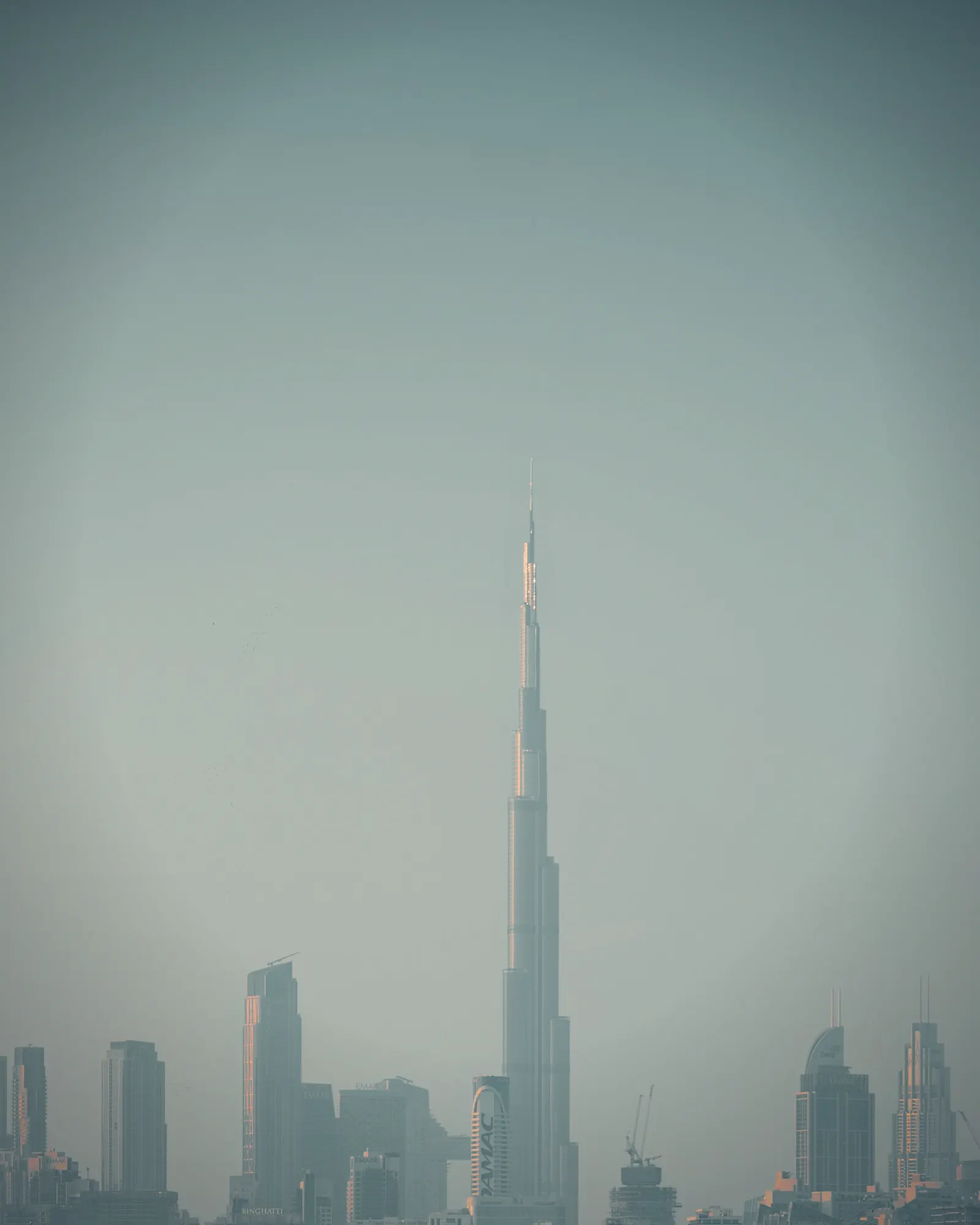 Burj Khalifa at sunrise above a curving road, Dubai